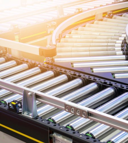 The machinery system for delivering goods in the material warehouse with a sliding mechanism, in a focus view on the sliding equipment.